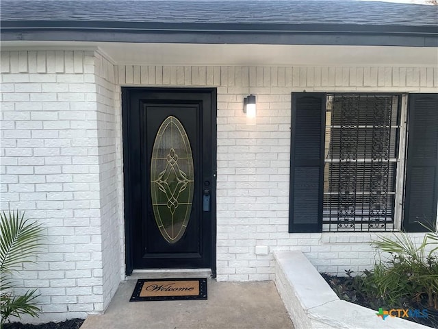 1218 Paseo Del Cobre, Temple, TX 76502 - entrance to property featuring a shingled roof and brick siding