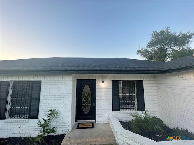 1218 Paseo Del Cobre, Temple, TX 76502 - doorway to property featuring brick siding and a shingled roof