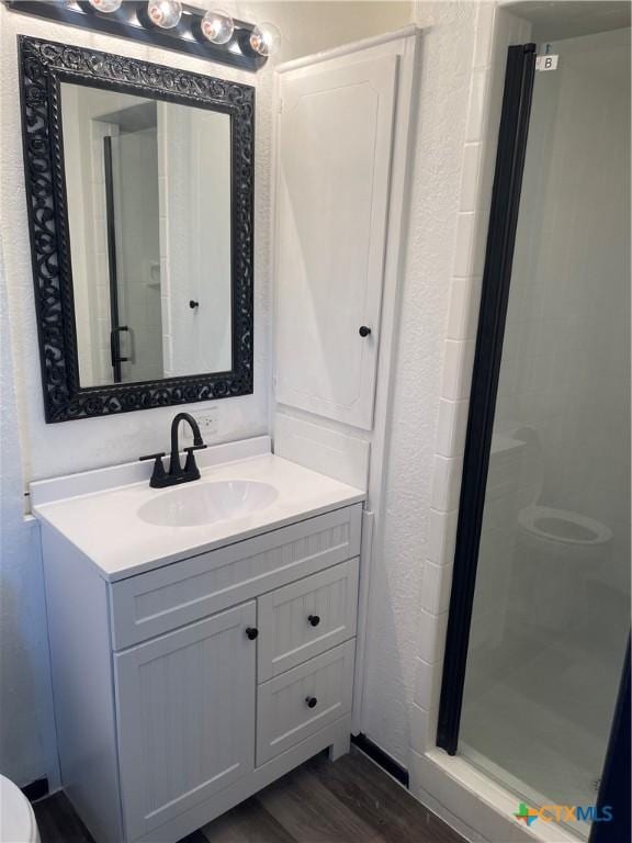 1218 Paseo Del Cobre, Temple, TX 76502 - full bath with vanity, a stall shower, and wood finished floors