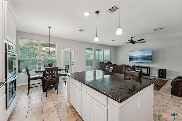 3225 Vineyard Trl, Harker Heights, TX 76548 - kitchen with double oven, open floor plan, white cabinets, a chandelier, and pendant lighting