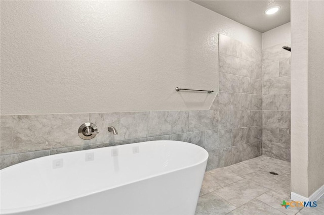 1536 Justice Dr, Copperas Cove, TX 76522 - full bath with a tile shower, a freestanding tub, and a textured wall