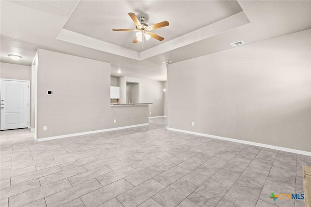1536 Justice Dr, Copperas Cove, TX 76522 - unfurnished living room featuring a raised ceiling and a ceiling fan
