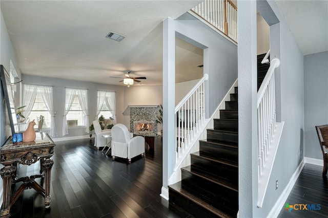 staircase featuring hardwood / wood-style flooring and ceiling fan