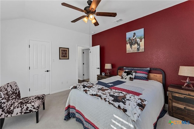 bedroom with ceiling fan, lofted ceiling, and carpet flooring