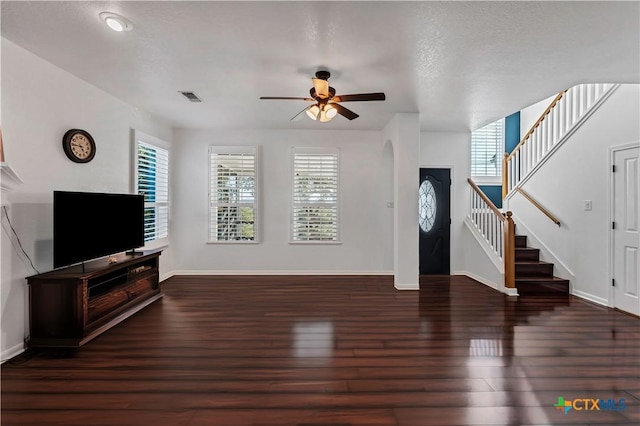 living room featuring dark hardwood / wood-style flooring and ceiling fan