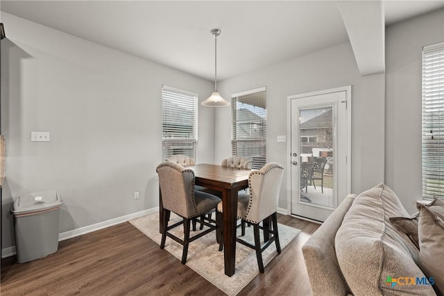 dining space with dark hardwood / wood-style floors