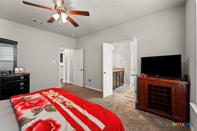 carpeted bedroom with ceiling fan and connected bathroom