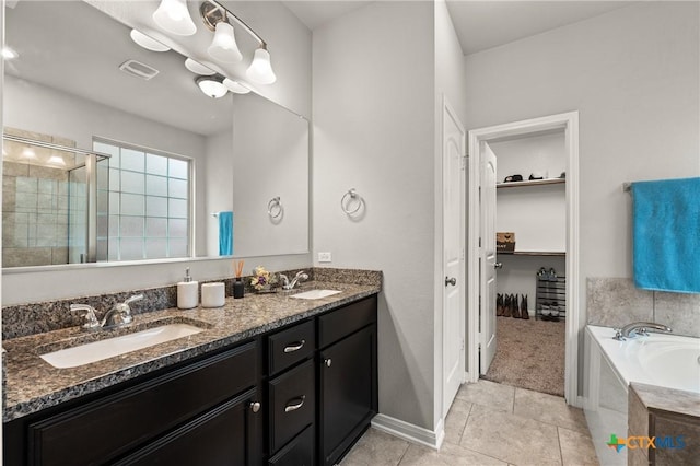 bathroom with separate shower and tub, vanity, and tile patterned floors