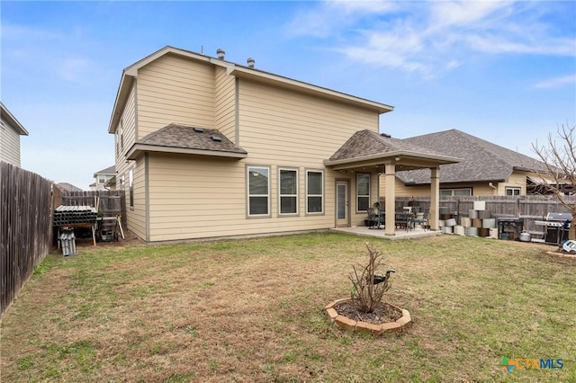 rear view of property with a patio and a lawn