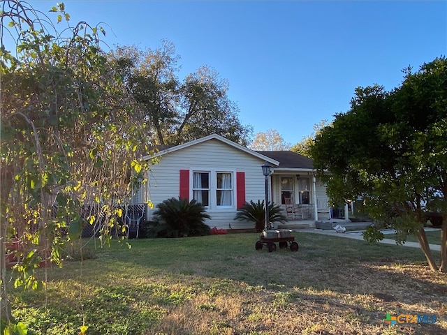 view of front of home with a porch and a front lawn