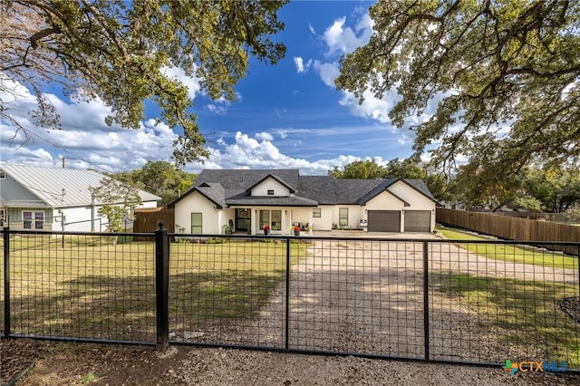 1428 Springwater, Canyon Lake, TX 78133 - view of front of property featuring a garage, a fenced front yard, stucco siding, and driveway