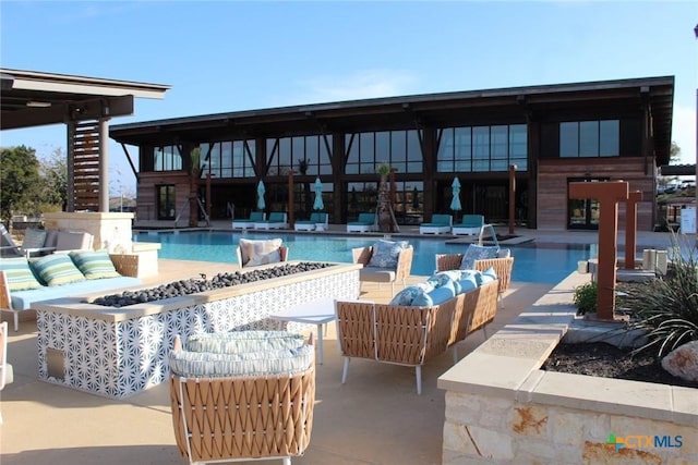 community pool featuring a patio area and an outdoor hangout area