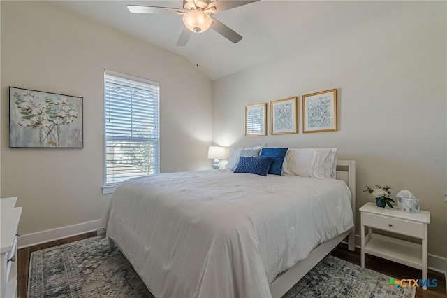 bedroom featuring ceiling fan, baseboards, lofted ceiling, and wood finished floors