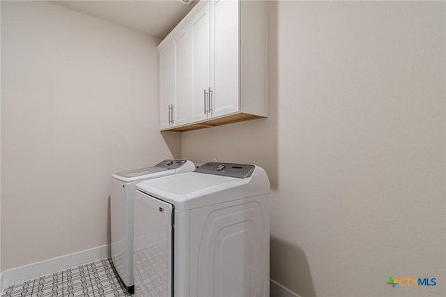 laundry room featuring cabinet space, washer and dryer, and baseboards