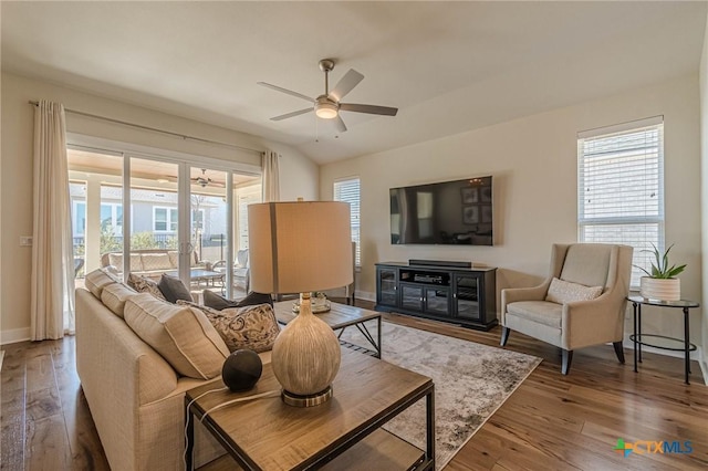 living room featuring ceiling fan, baseboards, plenty of natural light, and hardwood / wood-style floors