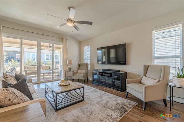 living room with a ceiling fan, lofted ceiling, wood finished floors, and french doors