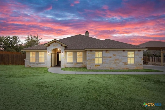 ranch-style home featuring a yard