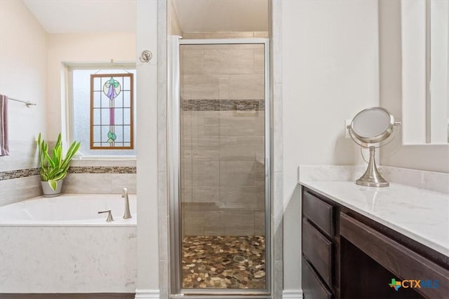 bathroom with independent shower and bath and vanity