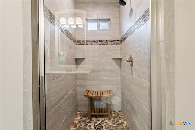 bathroom with a tile shower