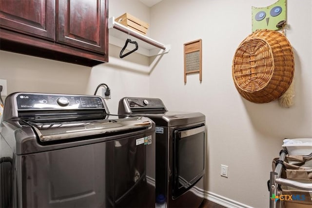 laundry area featuring cabinets and washing machine and dryer