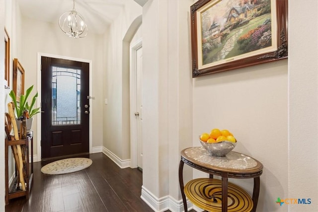 entrance foyer with a notable chandelier and dark hardwood / wood-style floors