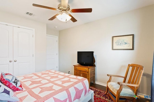 bedroom with ceiling fan, a closet, and wood-type flooring