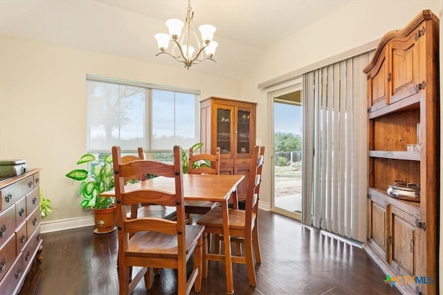 dining space featuring a chandelier, vaulted ceiling, and dark hardwood / wood-style floors