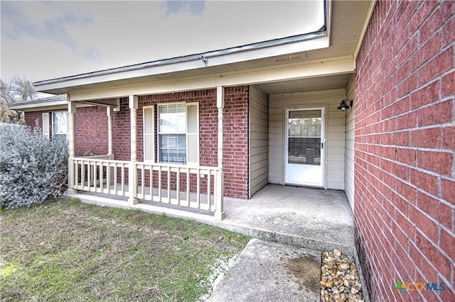 view of exterior entry featuring a porch