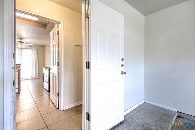 corridor with light tile patterned flooring