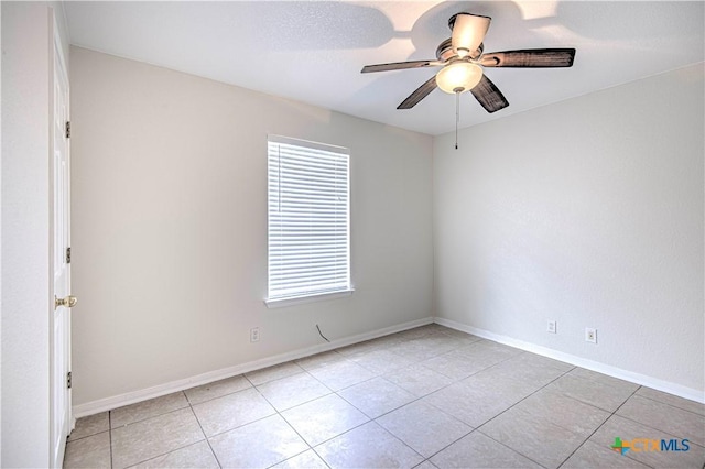 tiled spare room featuring ceiling fan