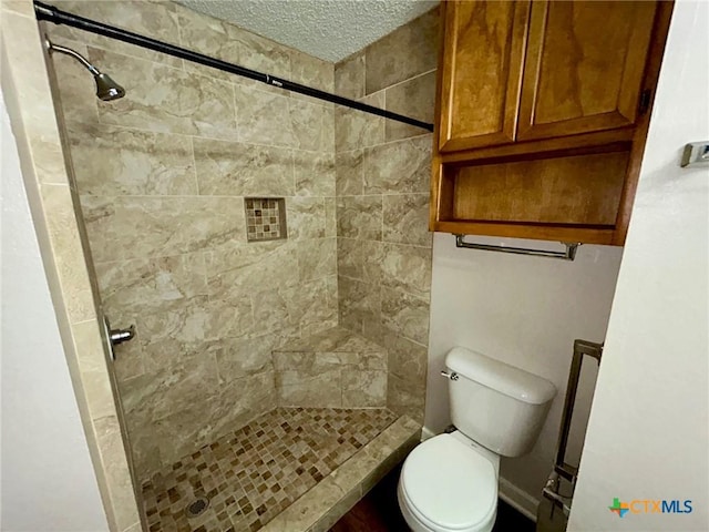 101 Chantilly St, Victoria, TX 77904 - bathroom with toilet, a stall shower, and a textured ceiling