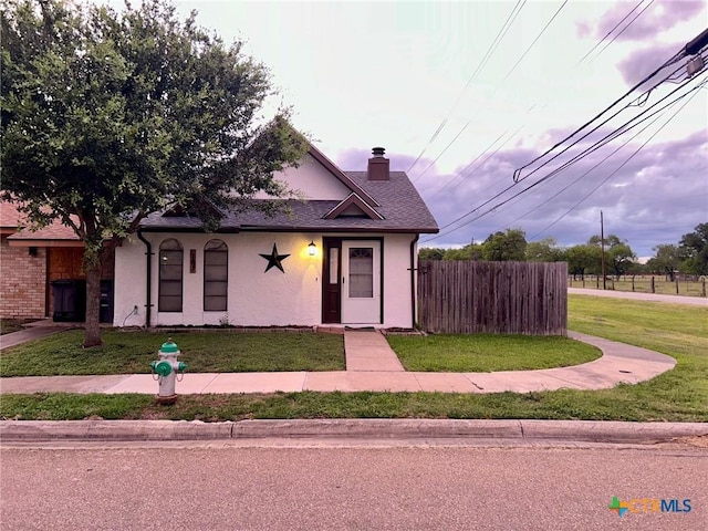 101 Chantilly St, Victoria, TX 77904 - view of front of home with a chimney, stucco siding, and roof with shingles