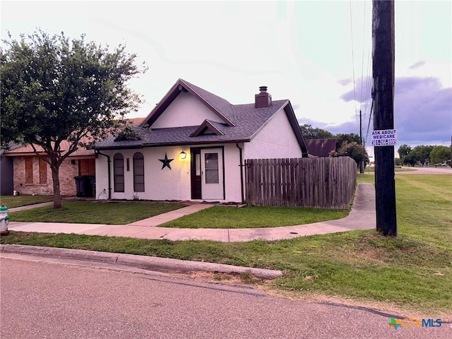 101 Chantilly St, Victoria, TX 77904 - view of front of house featuring a chimney, stucco siding, and roof with shingles