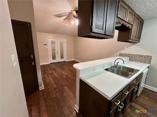 101 Chantilly St, Victoria, TX 77904 - kitchen with a textured ceiling, a sink, dark wood-style flooring, a ceiling fan, and light countertops