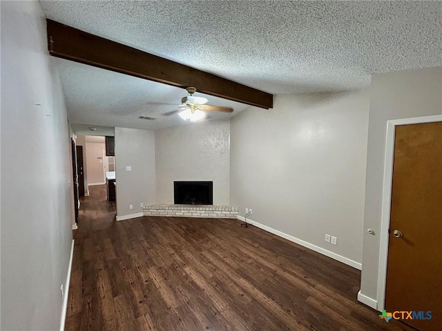 101 Chantilly St, Victoria, TX 77904 - unfurnished living room with ceiling fan, dark wood-style floors, beamed ceiling, a textured ceiling, and a brick fireplace