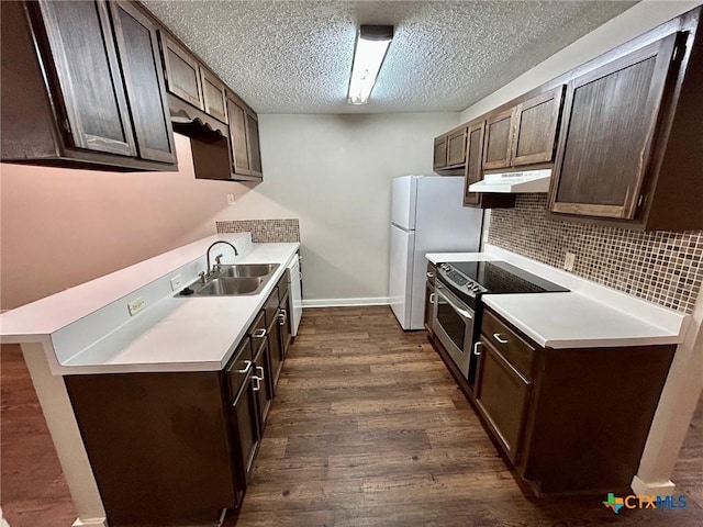 101 Chantilly St, Victoria, TX 77904 - kitchen featuring stainless steel range with electric cooktop, a sink, under cabinet range hood, dark brown cabinetry, and dark wood-style flooring