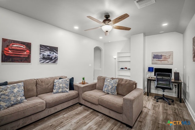 750 Cambridge Dr, New Braunfels, TX 78132 - living room with arched walkways, wood finished floors, recessed lighting, a ceiling fan, and baseboards