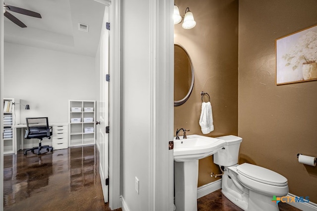 750 Cambridge Dr, New Braunfels, TX 78132 - half bathroom featuring toilet, finished concrete flooring, ceiling fan, baseboards, and a raised ceiling