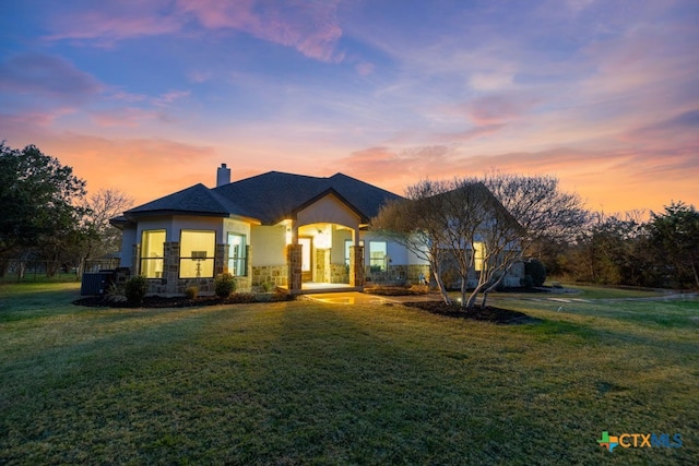 750 Cambridge Dr, New Braunfels, TX 78132 - view of front of property with a chimney, stucco siding, stone siding, and a front lawn