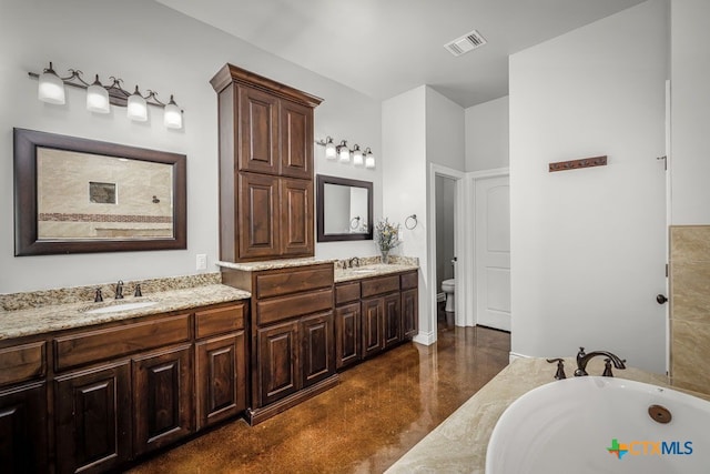 750 Cambridge Dr, New Braunfels, TX 78132 - full bathroom with double vanity, toilet, a bathtub, and finished concrete flooring