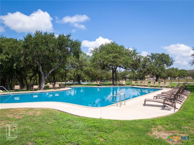 750 Cambridge Dr, New Braunfels, TX 78132 - community pool with a lawn, view of wooded area, and a patio