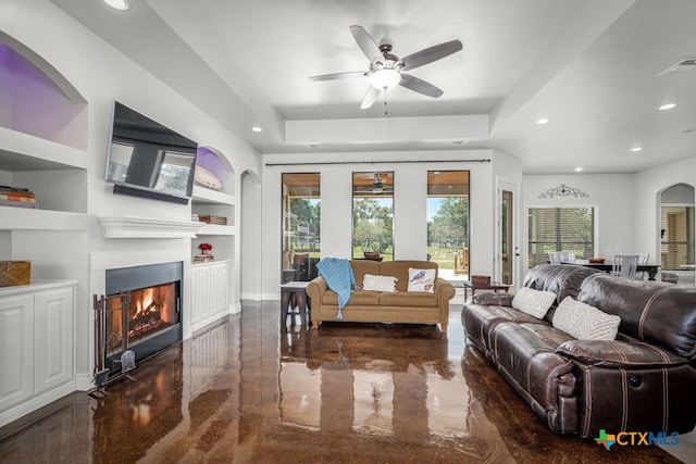 750 Cambridge Dr, New Braunfels, TX 78132 - living room featuring ceiling fan, recessed lighting, built in features, a tray ceiling, and plenty of natural light