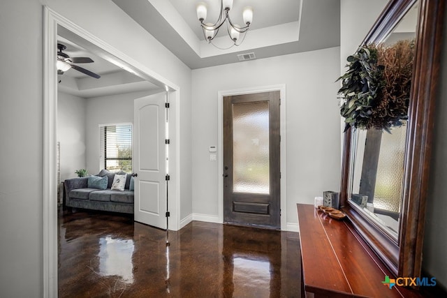 750 Cambridge Dr, New Braunfels, TX 78132 - foyer entrance featuring a raised ceiling, concrete flooring, baseboards, a chandelier, and ceiling fan