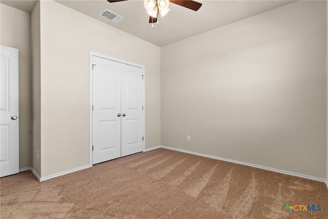 unfurnished bedroom featuring carpet flooring, ceiling fan, and a closet