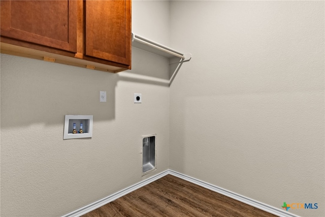 laundry area featuring cabinets, dark wood-type flooring, and hookup for a washing machine