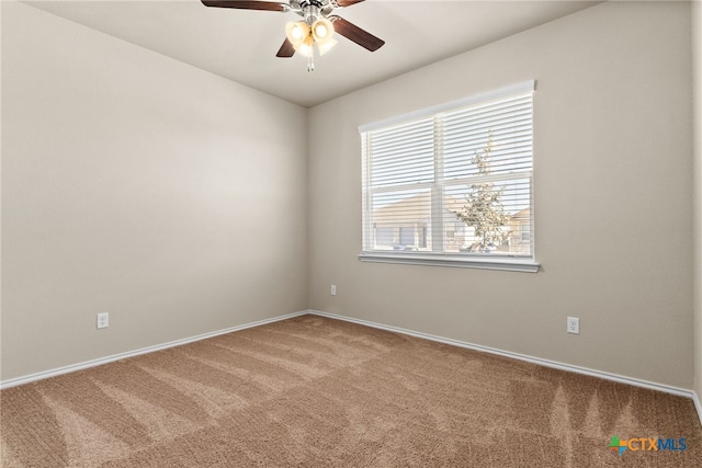 carpeted spare room with ceiling fan