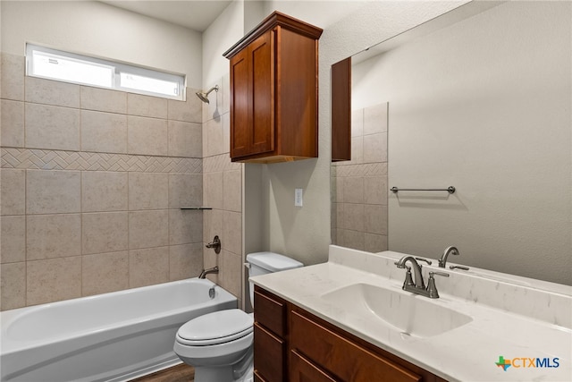 full bathroom with toilet, tiled shower / bath combo, and vanity