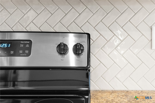 room details with decorative backsplash and stainless steel range oven