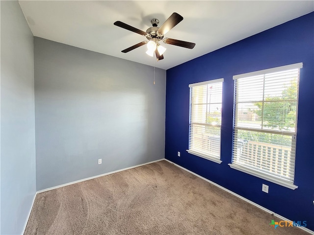 unfurnished room featuring ceiling fan, carpet flooring, and baseboards