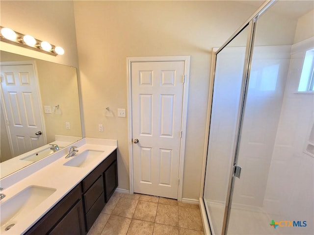 full bathroom featuring a sink, a shower stall, and double vanity